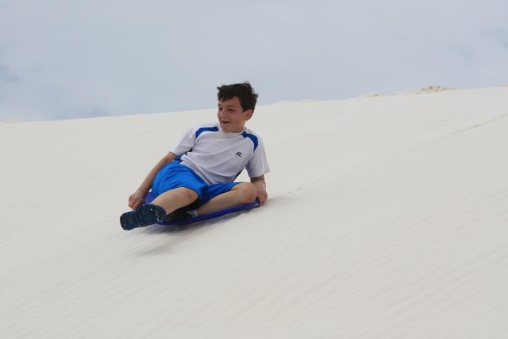 Jonathan sledding at White Sands