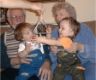 Grandpa and Grandma with boys on couch,&nbsp;