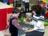 Jonathan shows Mrs. Munoz&nbsp; a dinosaur.