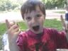 Jonathan eats a tootsie roll at an old fashioned baseball game.