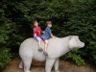 Jonathan and Robert ride the bear statue