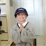 Jonathan wears dad's shirt and hat