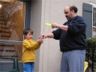 Dad shows Robert how to throw water balloons
