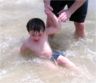 Robert gets knocked down by a wave
