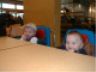Robert and Jonathan sit in high chairs